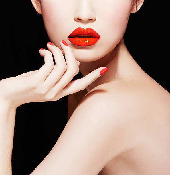 Beautiful makeup. red lips, nail polish manicure.isolated on black. stock photo