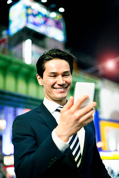 istock Japanese businessman using smart phone, Tokyo. 503818740