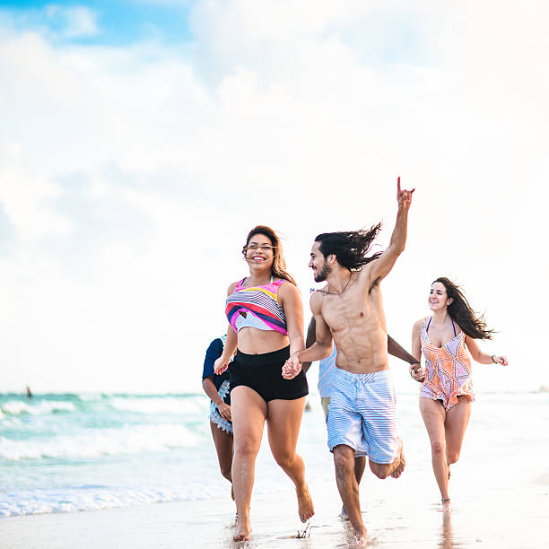 istock Group of friends running on the beach 503818744