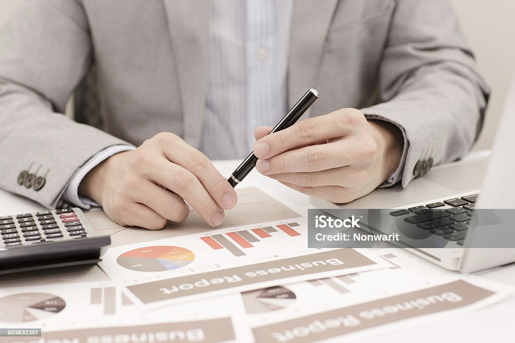 Businessman analyzing investment charts with laptop. Accounting Adult Stock Photo