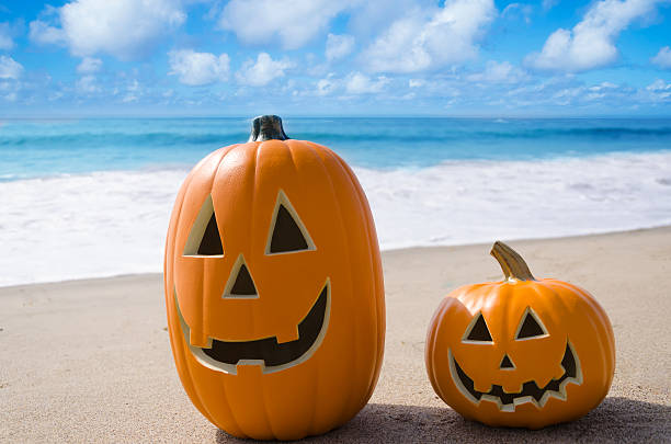 Halloween pumpkins on the beach stock photo