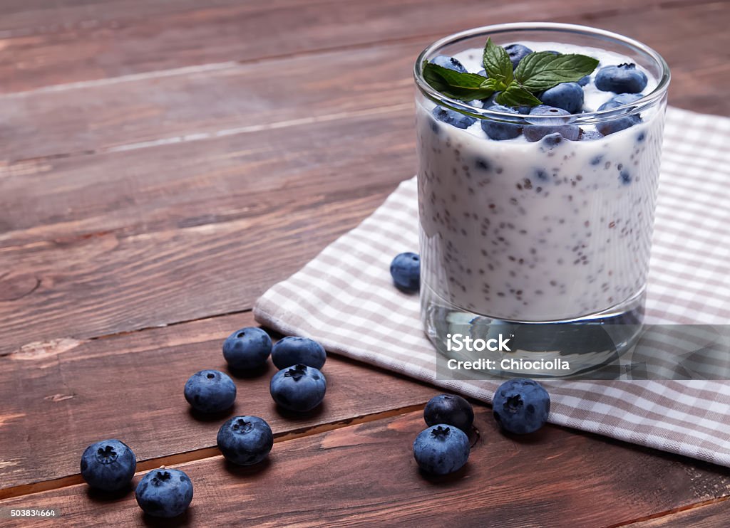 Chia pudding in a glass Healthy breakfast. Pudding with chia seeds and blueberries.Chia seeds pudding in a glass with yougurt and  blueberries close-up Dessert - Sweet Food Stock Photo