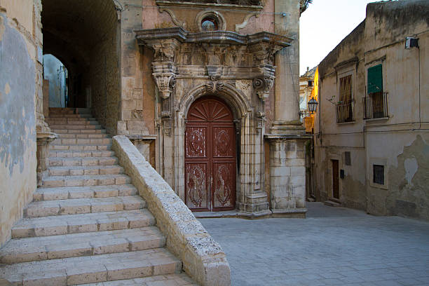 A small 18th-century baroque Sicilian piazza with stairs and cobblestones. Shot in Ragusa Ibla, Sicily, Italy.