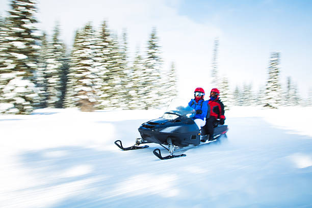 istock Woman and kid on snowmobile 503836510