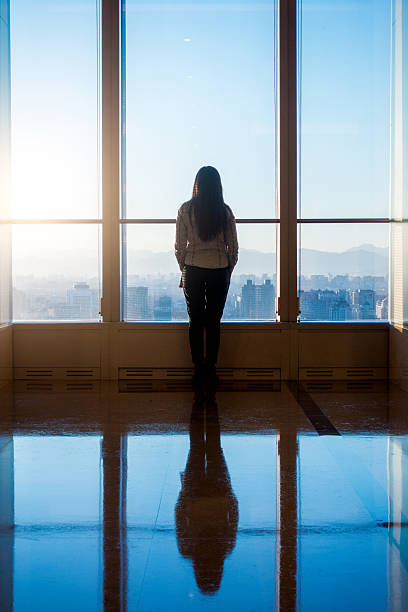 istock Businesswoman looking through the window 503837518