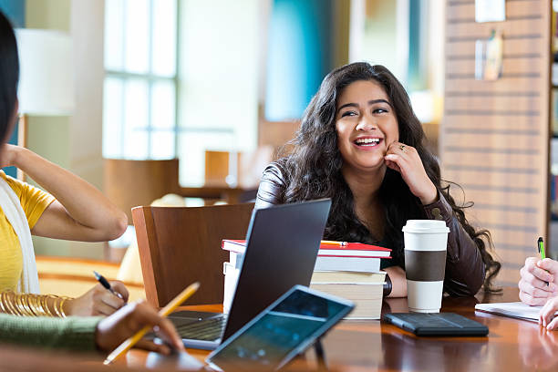 istock Teen study group hanging out in library after school 503838658