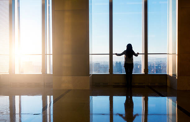 istock Woman looking cityscape through the window 503838958
