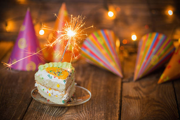 istock cake with sparkler on table on wooden background 503840722