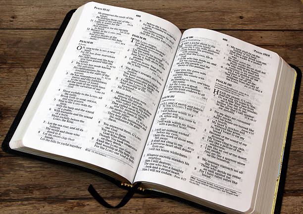 istock Bible open to Psalms and is lying on wood table 503843376