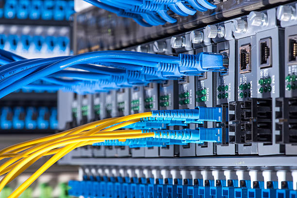 Fiber Optic cables and UTP Network cables Fiber Optic cables and UTP Network cables connected hub ports. fiber optic stock pictures, royalty-free photos & images