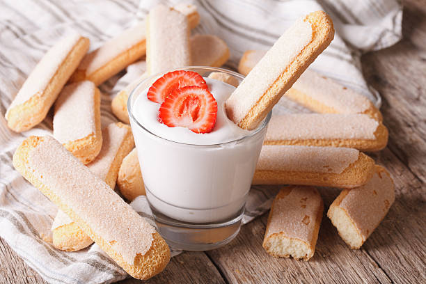 Dessert of Savoiardi with yogurt and strawberries. horizontal Dessert of Savoiardi with yogurt and strawberries. horizontal yogurt fruit biscotti berry fruit stock pictures, royalty-free photos & images