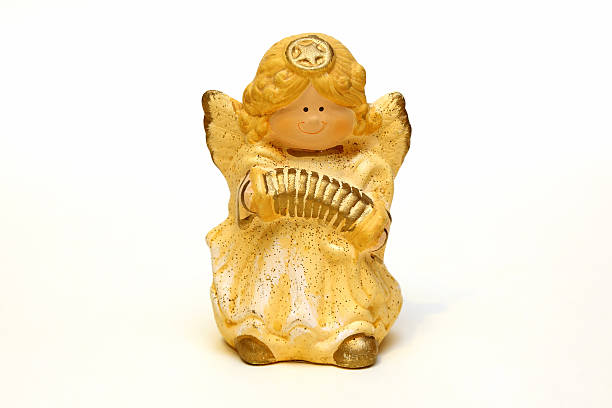 istock ceramic angel figurine yellow on a white background 503848900