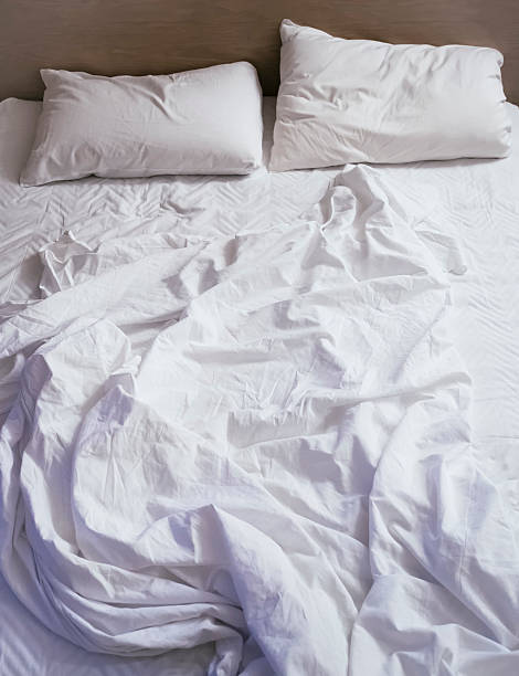 istock Bed Mattress Pillows Blanket messed up Top view 503849364