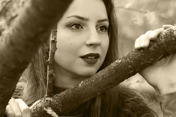 Beautiful woman holding autumn dry leaves