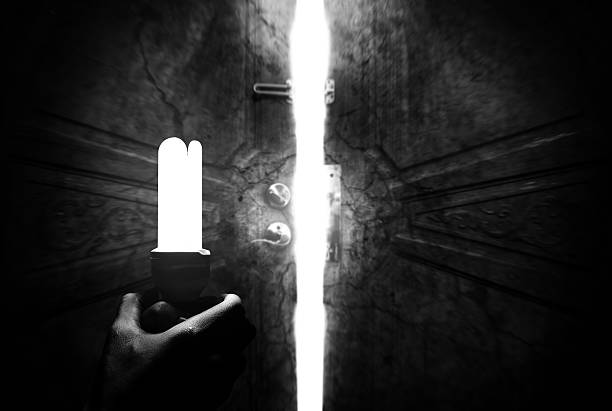 istock Haunted cracking open the door handles light bulbs. 503862796