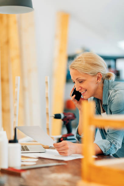 istock Mature female carpenter on the phone 503864332
