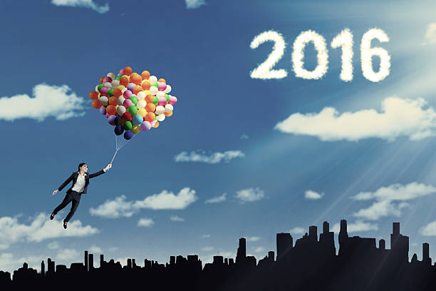 istock Woman flying with balloon and numbers 2016 503864420