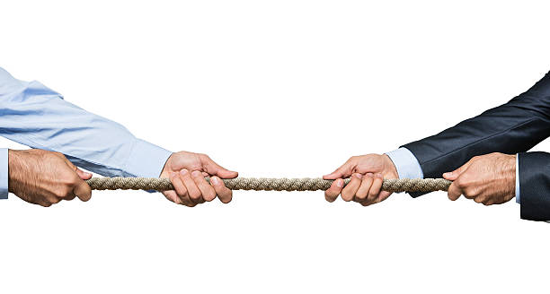 Tug of war Two businessmen pulling a rope in opposite directions isolated on white background rivalry stock pictures, royalty-free photos & images