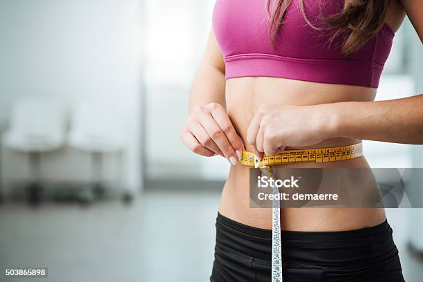 Slim Woman Measuring Her Thin Waist Stock Photo - Download Image Now - Dieting, Women, Slim