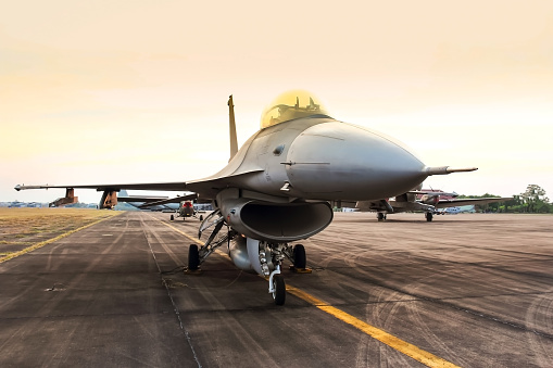 f16 falcon fighter jet on sunset  background 