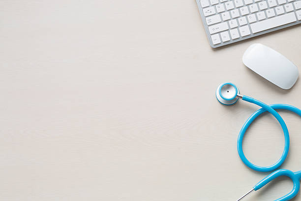 Stethoscope in doctors desk stock photo