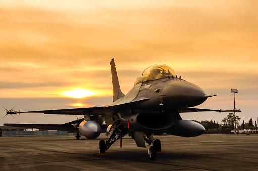  f16 falcon fighter jet in the base on sunset  background 