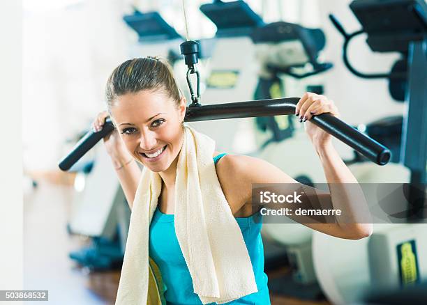 Attractive Woman Exercising At Gym Stock Photo - Download Image Now - Teenager, Weight Training, Health Club