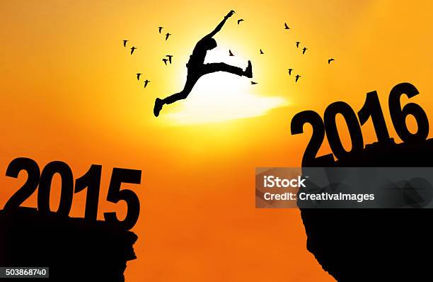 Man Leap Over Cliff With Numbers 2015 And 2016 Stock Photo - Download Image Now - 2015, 2016, Adult