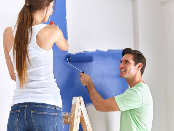 istock Couple painting wall 503869740
