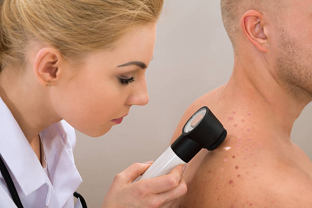 istock Doctor Examining Pigmented Skin 503869834