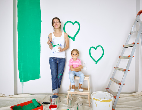 Mother and daughter painting hearts