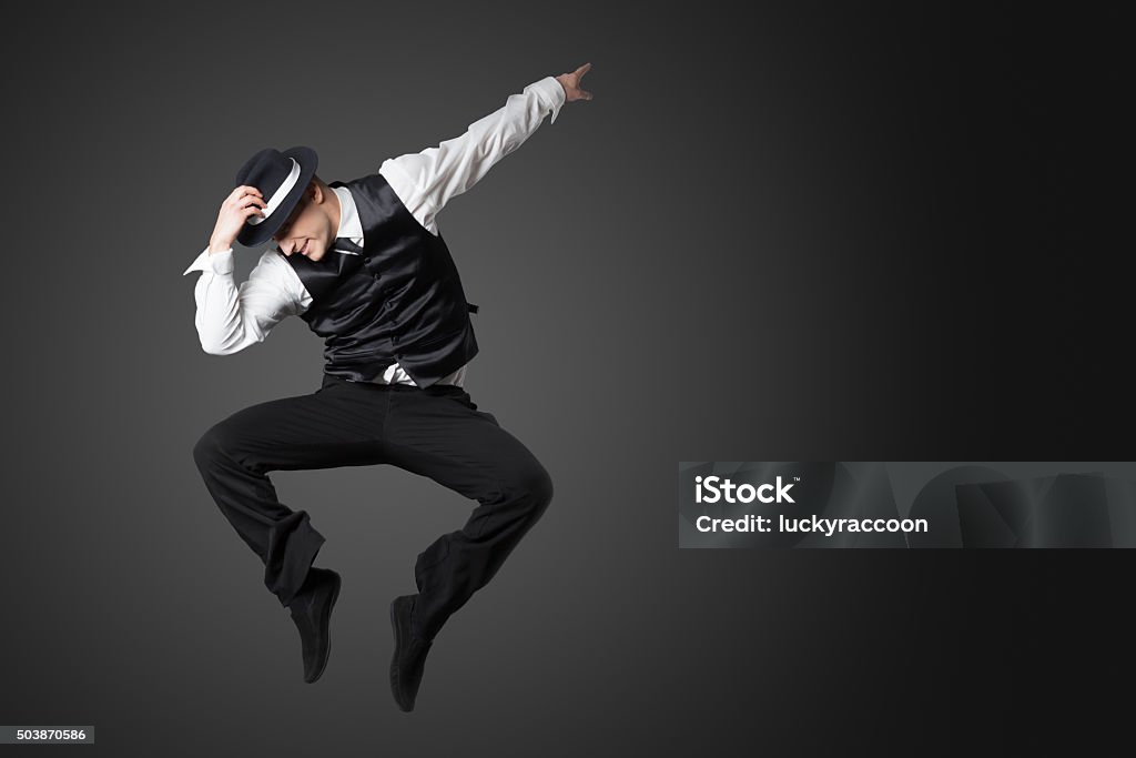 Young male professional dancer dancing in studio. Young male professional dancer dancing in studio isolated on gray background. Dancing Stock Photo