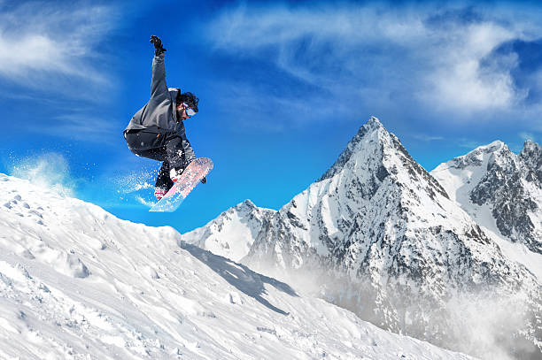 Extreme snowboarding man Snowboarder jumping high in the air snowboarder stock pictures, royalty-free photos & images