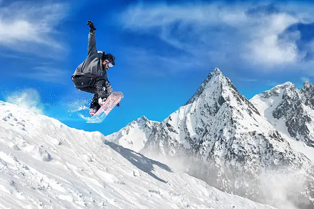 Snowboarder jumping high in the air