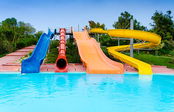 At the Waterpark Empty colorful water slides and pool aquatic organism stock pictures, royalty-free photos & images