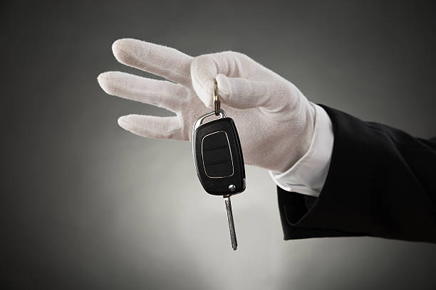 Waiter Hands Holding Car Key Close-up Of Waiter Hands In White Glove Holding Car Key formal glove stock pictures, royalty-free photos & images