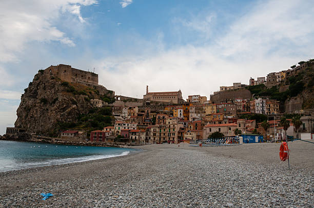 istock Stone beach and old small italian town on cliff under 503873190