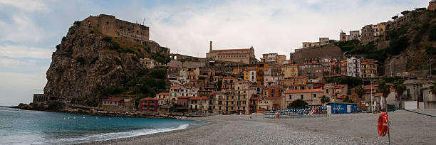 istock Stone beach and old small italian town on cliff under 503873230