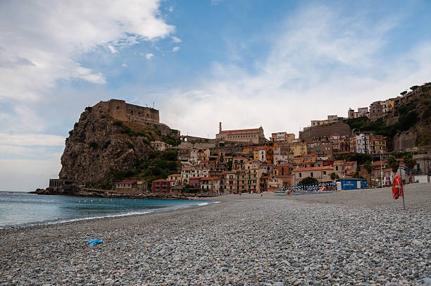 istock Stone beach and old small italian town on cliff under 503873252