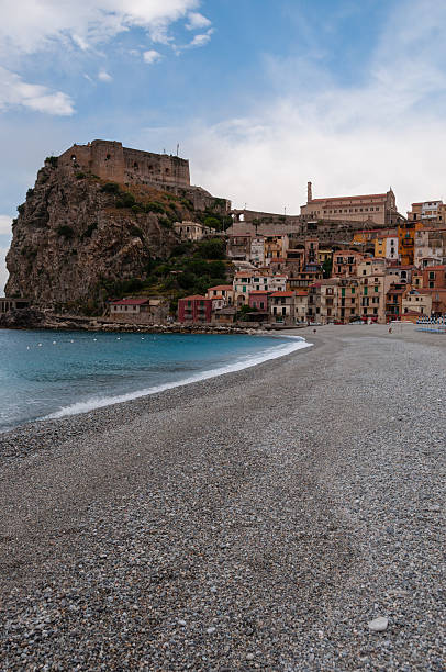istock Stone beach and old small italian town on cliff under 503873272