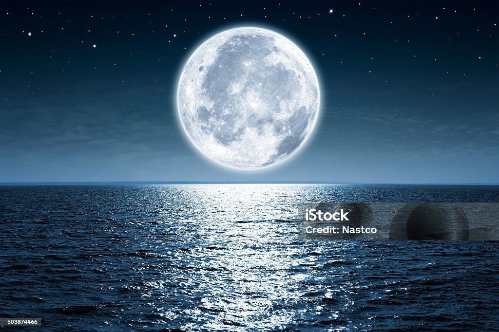 Full moon Full moon rising over empty ocean at night with copy space Moon Stock Photo