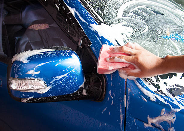 istock hand hold sponge over the car for washing 503887163