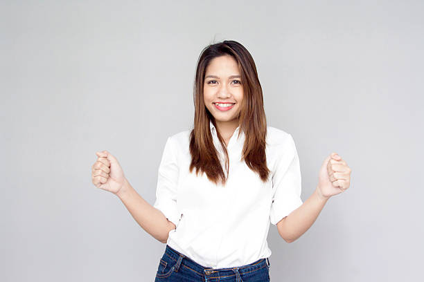 istock Portrait Asian lady show handful and smile on gray isolate 503887687