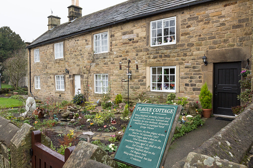 Eyam, United Kingdom - January 1, 2016: In 1665 residents of these cottages succumbed to the Bubonic Plague outbreak in the Peak District village of Eyam in Derbyshire, UK. The  Bubonic plague ran its course over 14 months and one account states that it killed at least 260 villagers, with only 83 surviving out of a population of 350.