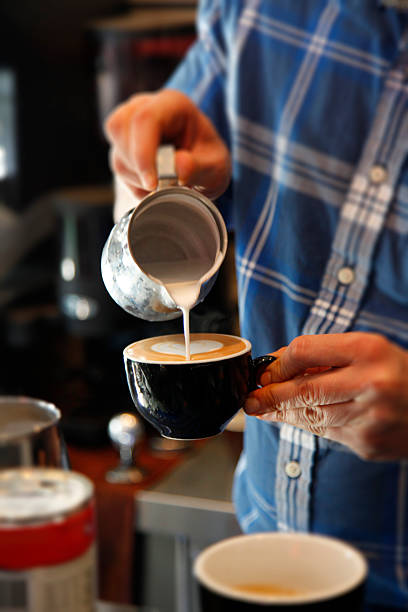 istock droping milk cream on cappuccino coffee latte 503888312