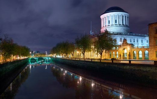 Dublin river liffey and court house illuminater at night