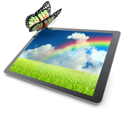 Monarch butterfly resting on a tablet computer