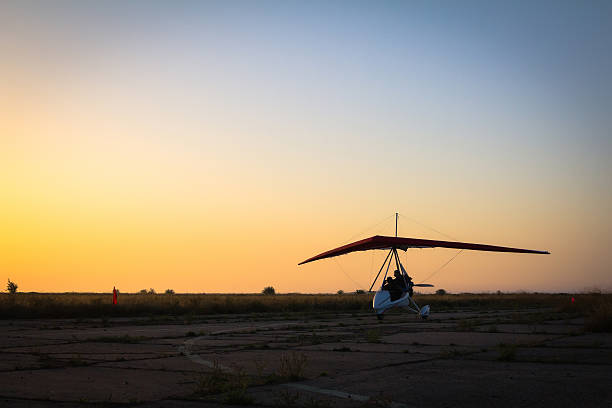 istock Hang-gliding, standing at dawn on the runway 503890232