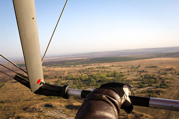 Hand paraglider pilot holding the bar