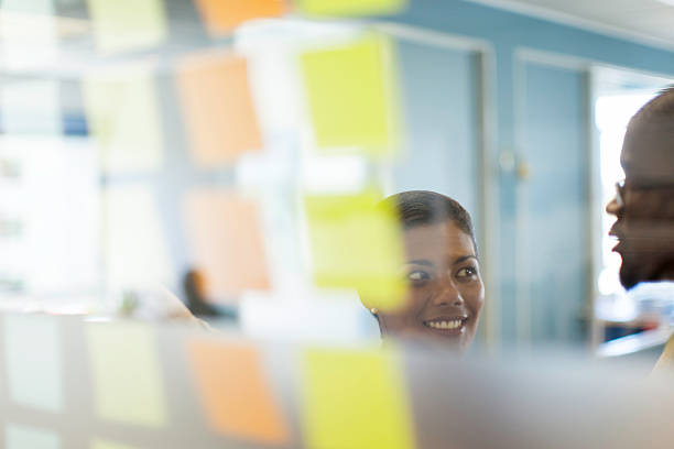istock African business colleagues working from sticky notes. 503890939